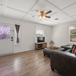 Living room with the front door, sectional and TV