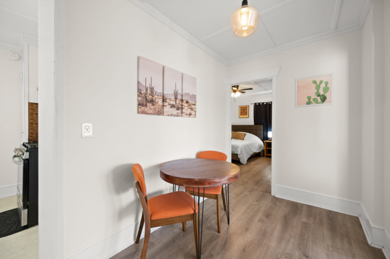 Dining nook for four with a view into the bedroom