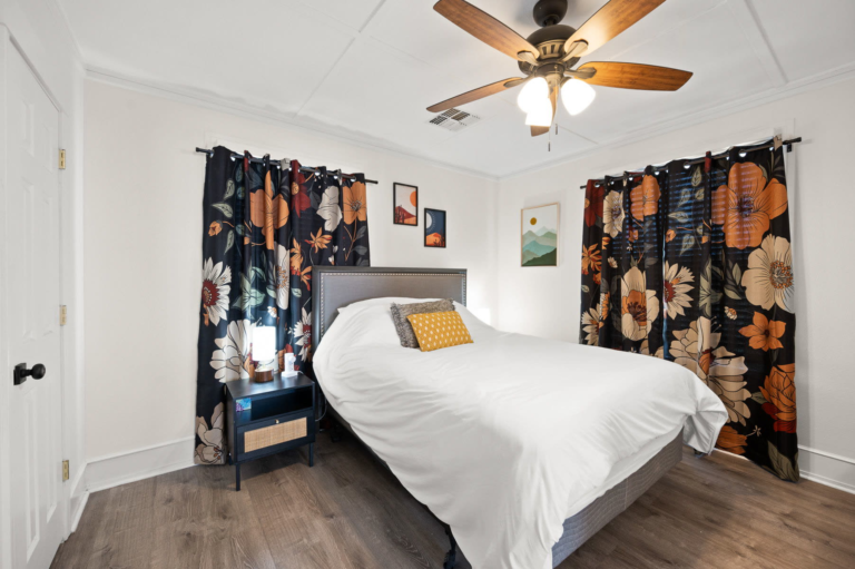 Bedroom with a queen bed and floral curtains