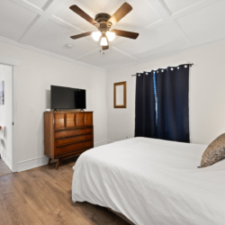 Second bedroom with dresser and TV