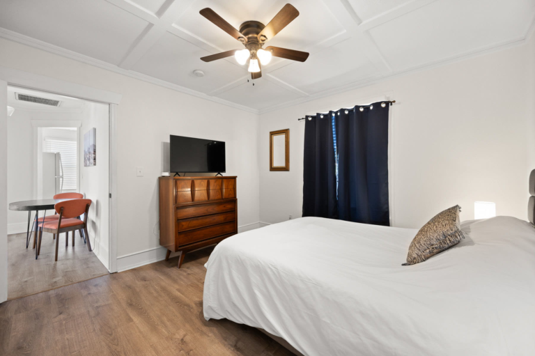 Second bedroom with dresser and TV