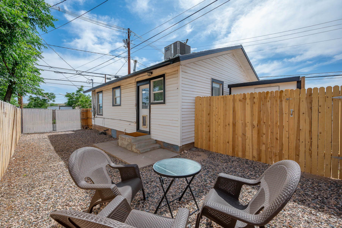 Private fenced backyard with patio seating
