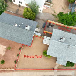 Aerial view of the home and its private fenced yard